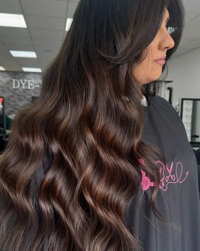 A golden balayage toned down to a warm mocha by Mollie