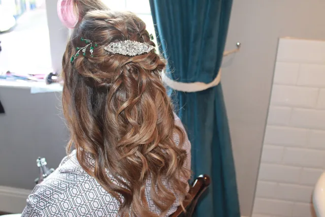 An elegant half-up occasion style with a hair jewel